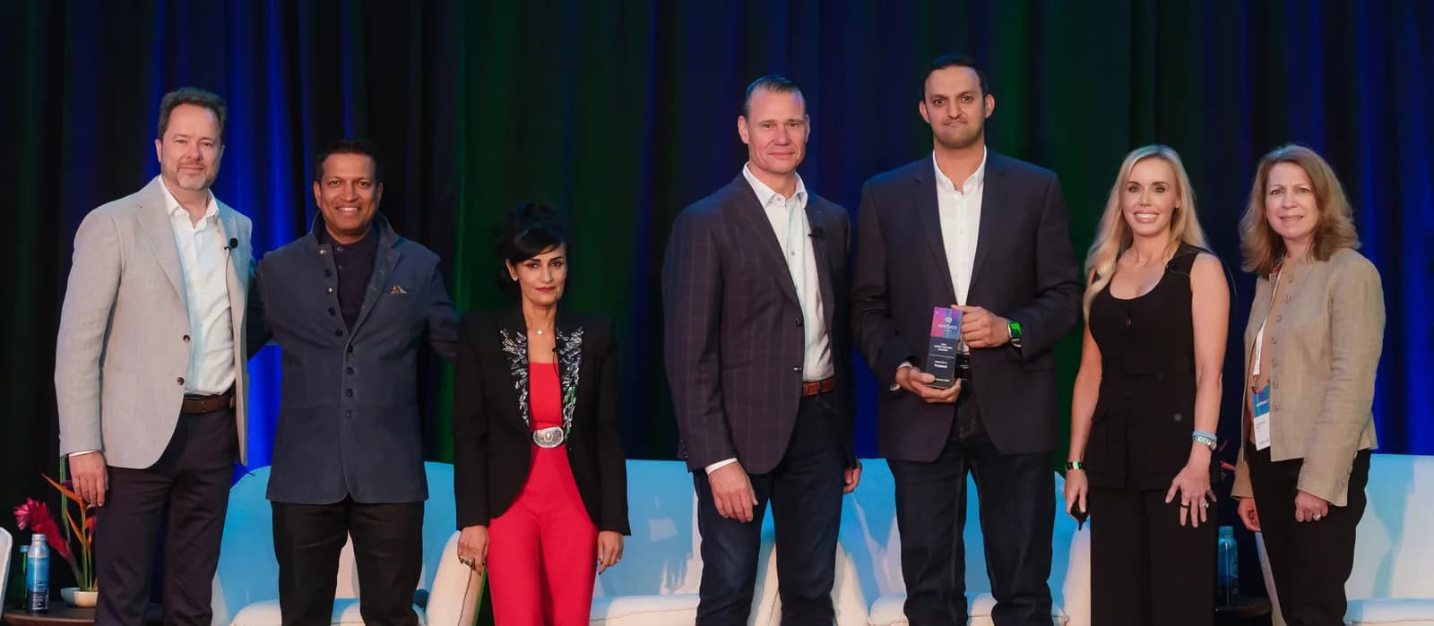 Twaasol accepting the Webex Rising Star award on stage at WebexOne 2025 in San Diego.